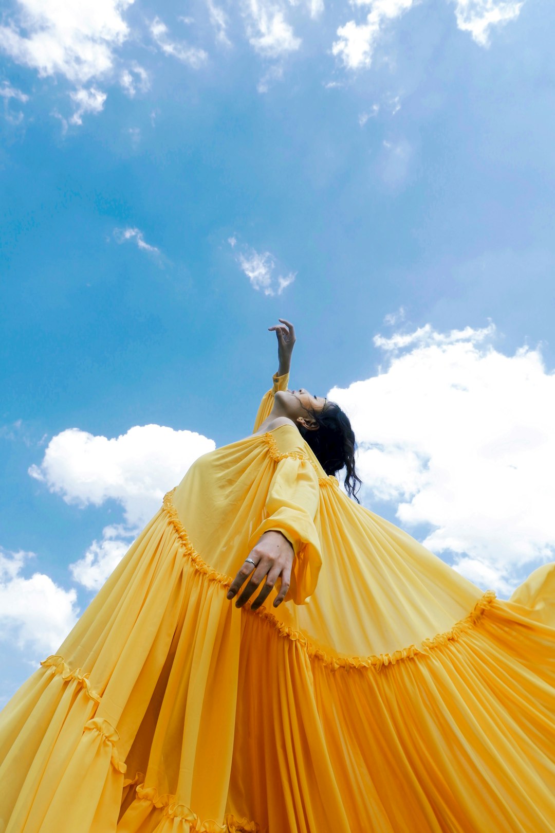 journey woman-wearing-yellow-long-sleeved-dress-under-white-clouds-and-blue-sky-during-daytime-fo-zqd7wqio